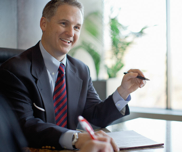 James Bates Partner Sitting At Desk